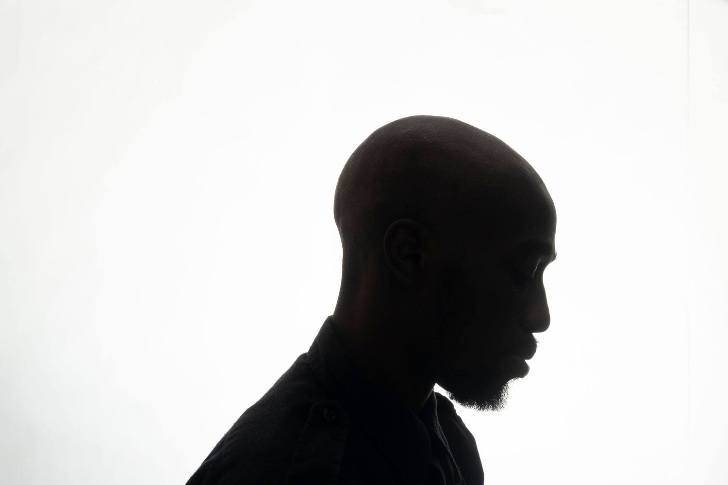 Black and white photo of Prince Lang. The photo is a high contrast silhouette of his profile.